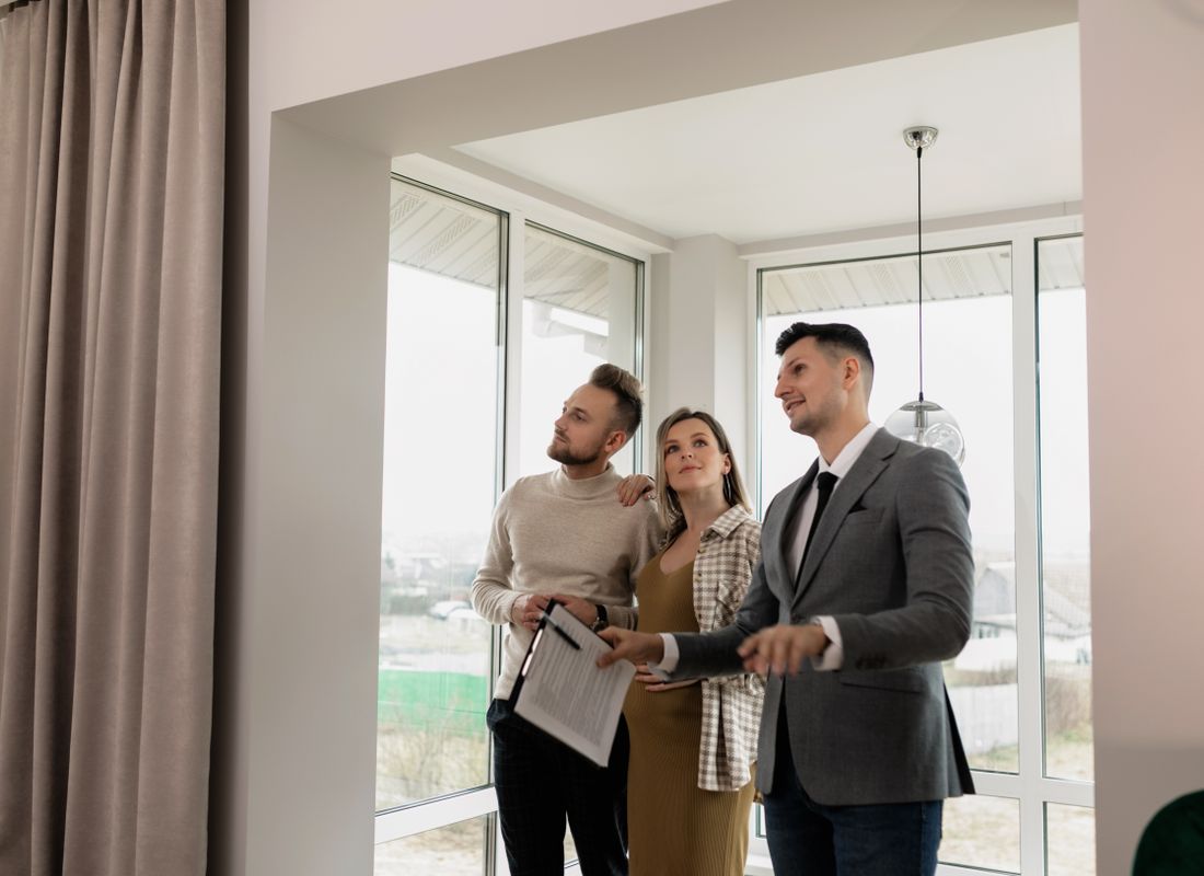 An agent showing the house to prospective buyers